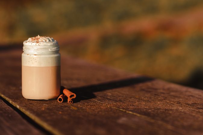 Cinnamon near coffee on table