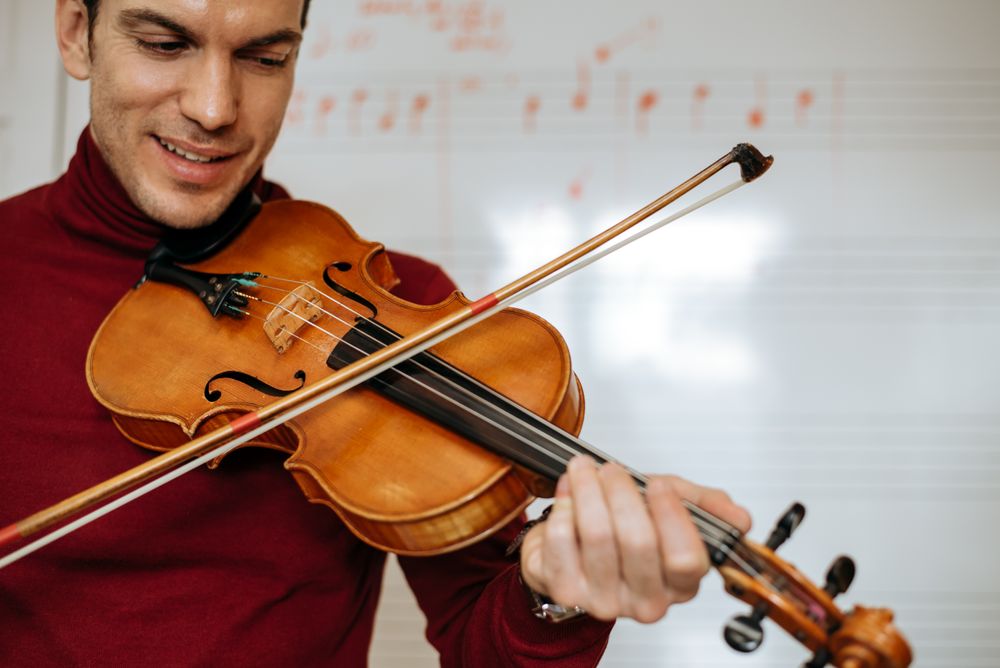 Man playing violin in studio