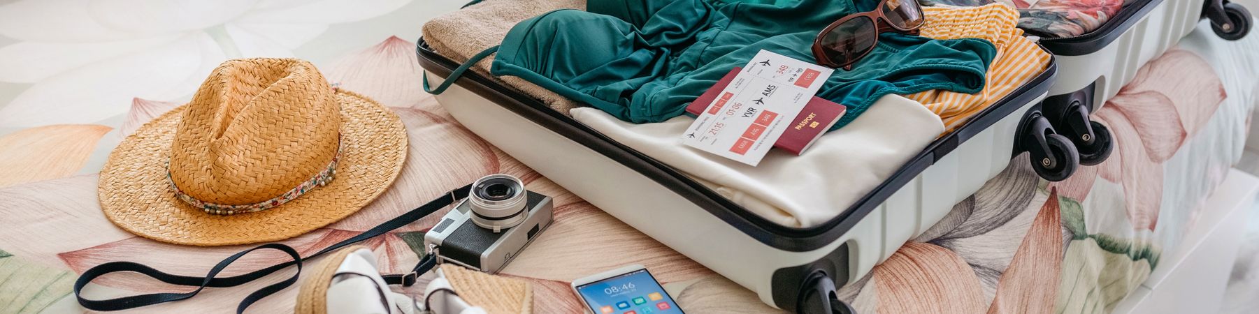 Open woman suitcase prepared for summer vacation