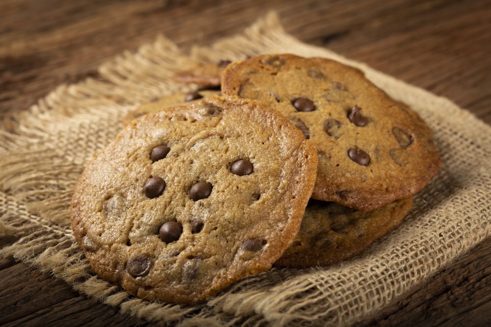 Delicious chocolate cookies on wooden table.