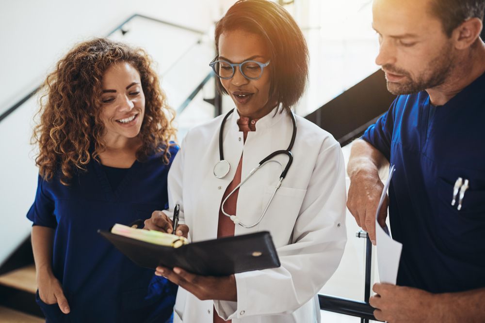 Group of doctors and nurses going over notes together