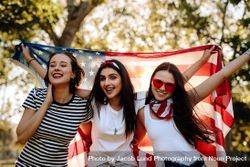 Group of young women smiling with American flag 48Oe75