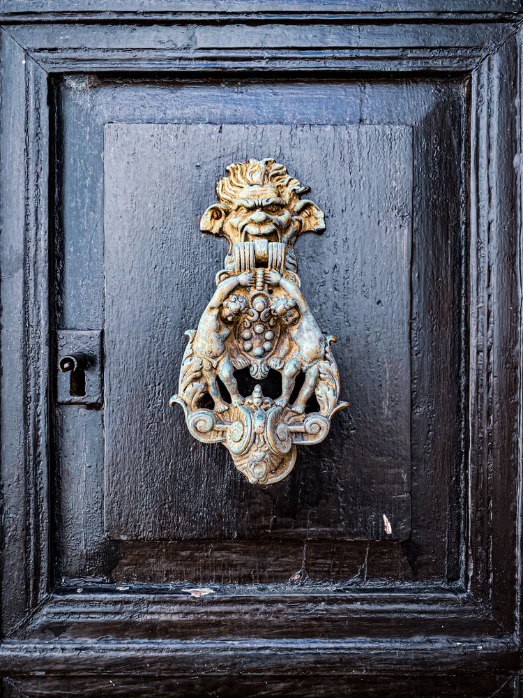 Patmian knocker close up of deity with supporting infants