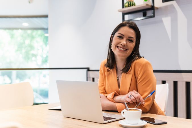 Content woman working on project in cafe