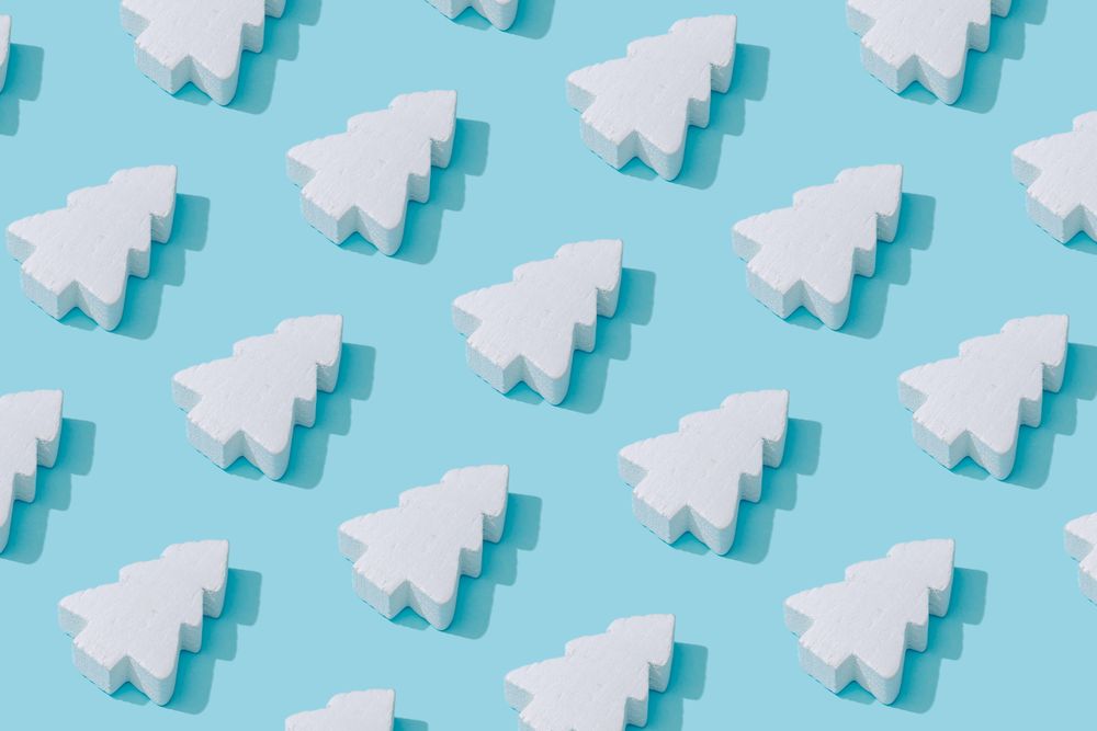 Pattern composition of light  Christmas trees on pastel blue background