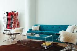 Living room with bright couch and lucite table in light-filled room
