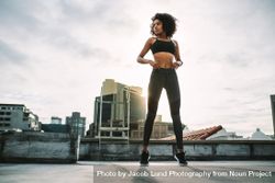 Fitness woman standing on her toes doing exercises on rooftop 4ddXA4