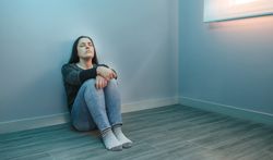 Stressed woman sitting with closed eyes relaxing