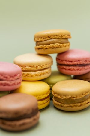 Delicious macaroon desserts with a green background