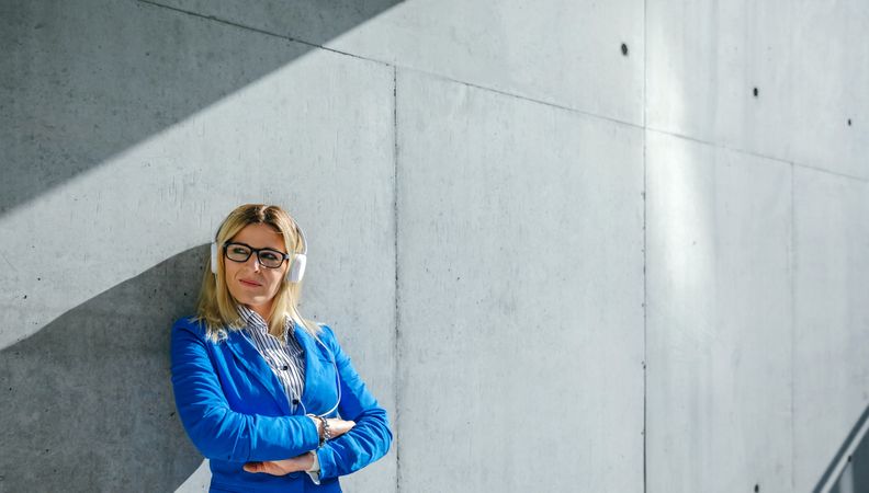 Businesswoman with headphones posing