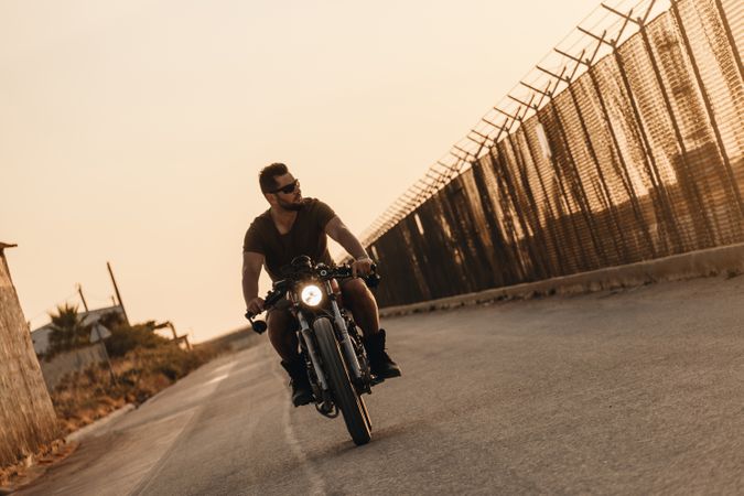 Strong man driving motorcycle