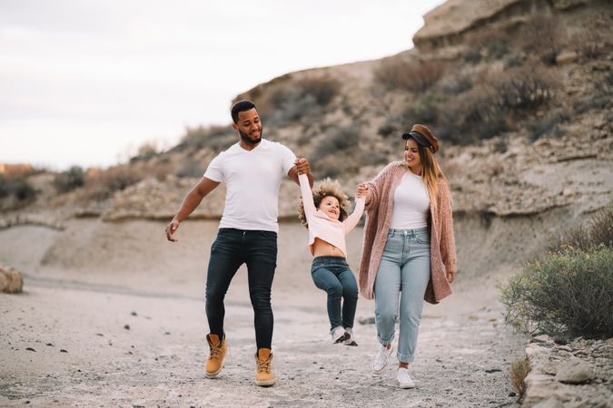Stylish multiethnic family walking on nature