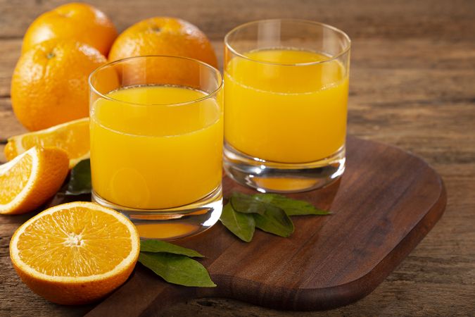 Glass with orange juice on the table.
