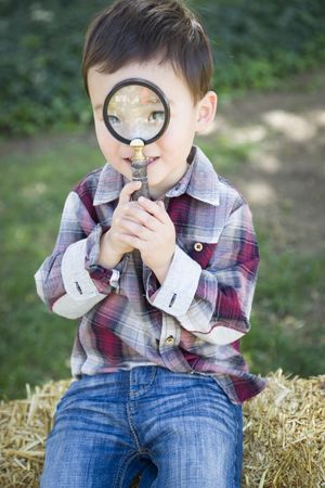 Curious Boy Looking Through Magnifying Glass