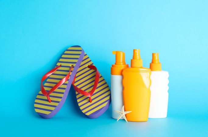 Summer vacation accessories on color background, space for text. Safe tan