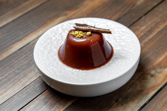 Elegant chocolate dessert with pistachio topping on a plate