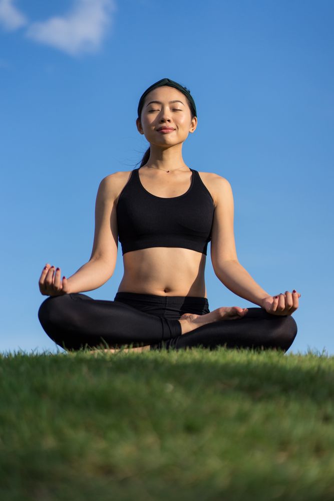 Woman meditating on the beach