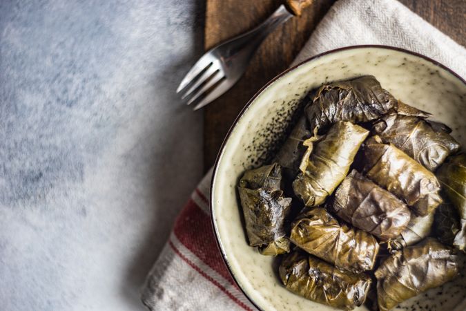 Close up of bowl of stuffed grape leaves
