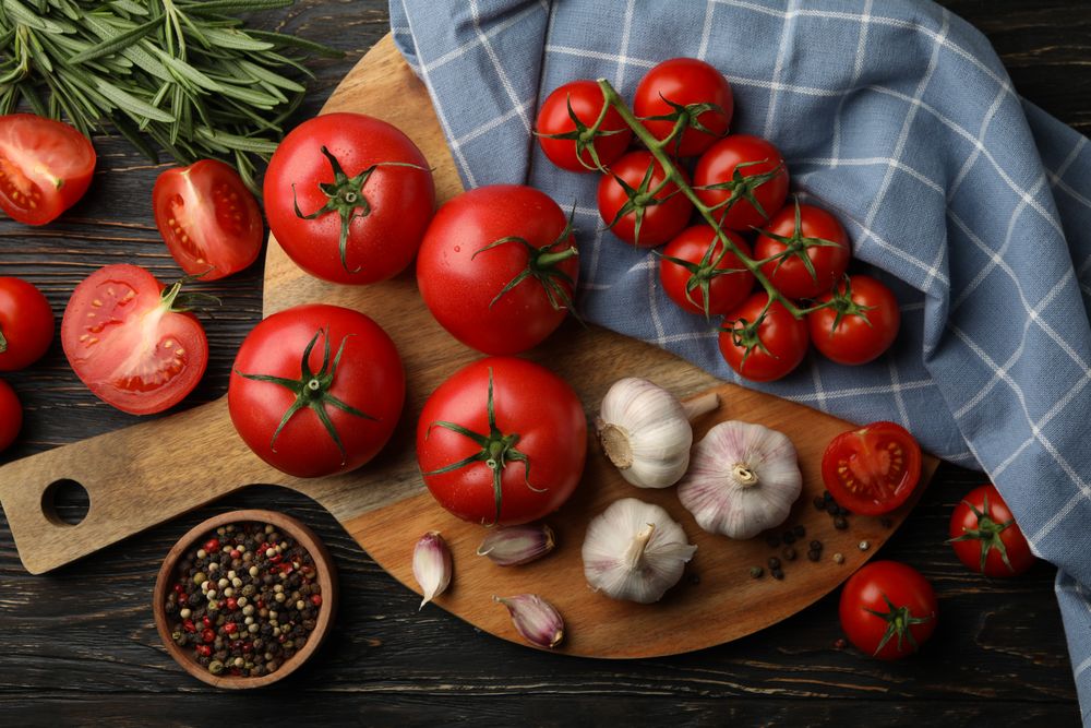 Composition with tomatoes on wooden background. Ripe vegetable
