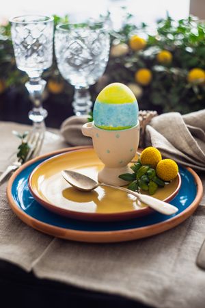 Easter table setting with eggs on table with crystal glassware