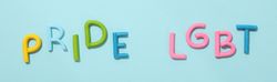 LGBT parade concept, festive colorful symbols on blue background.