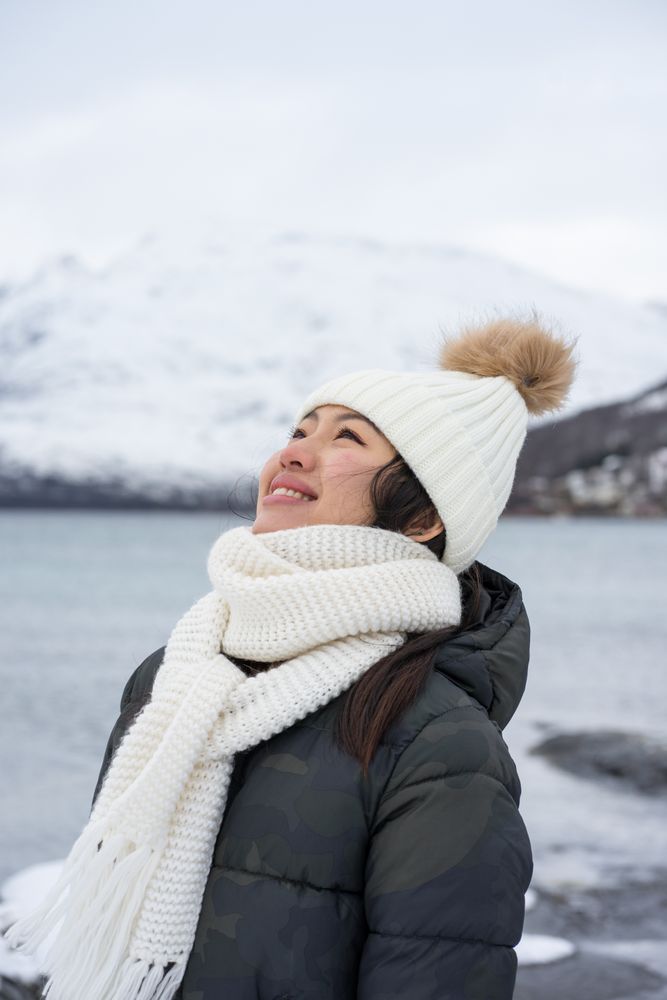Joyful young woman in warm clothes
