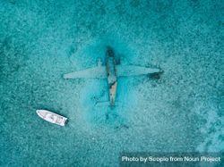 Aerial view of light boat on sea above plane sunk in water 5k6Dj0