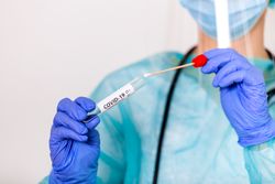 Healthcare person holding Coronavirus test kit