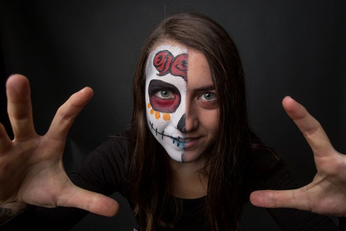 Young woman with creepy face paint
