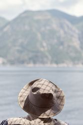 Man in hat against misty seascape