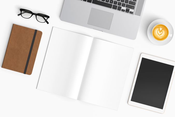 Modern workspace with coffee cup, smartphone, paper, notebook, tablet and laptop