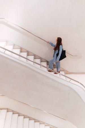 Unrecognizable woman walking on stairs