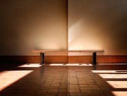 Empty bench in sunbeam indoors