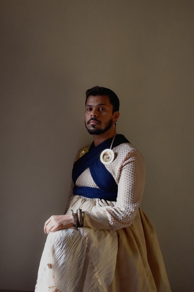 Man wearing a dress and earrings