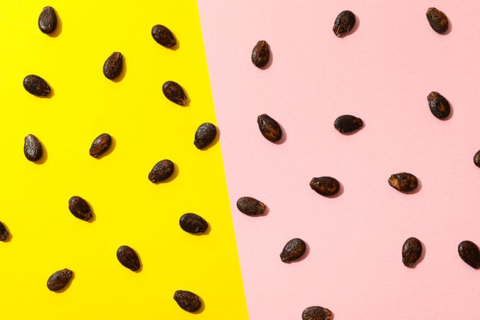 Watermelon seeds on two tone background, top view