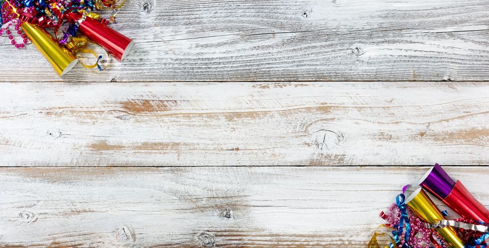 Happy New Year Celebration with party objects in right and left corners on rustic wooden boards