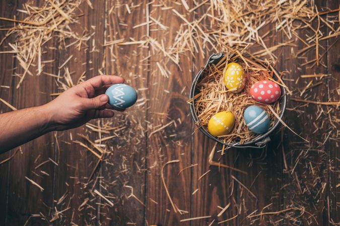 Hand placed Easter eggs on wooden stump