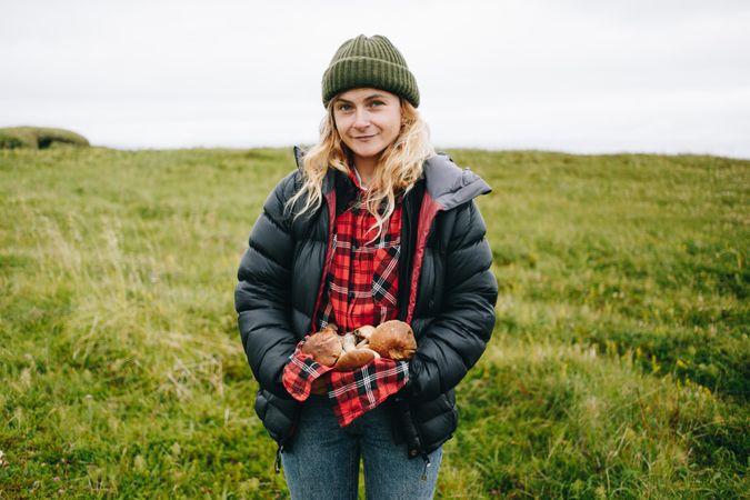 Woman holding foraged mushrooms