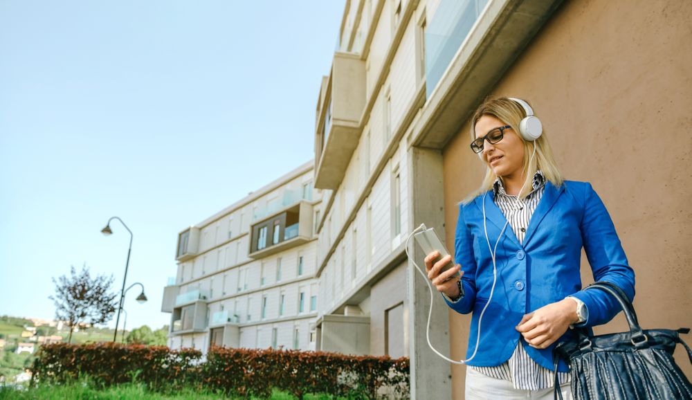 Businesswoman with headphones and mobile