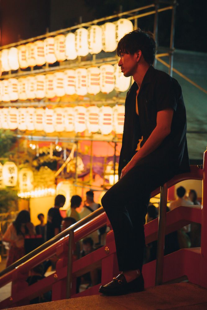 East Asian man with messy hair outdoor