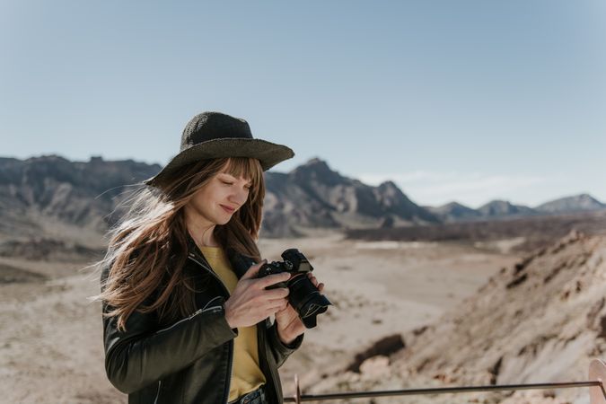 Woman with camera in desert