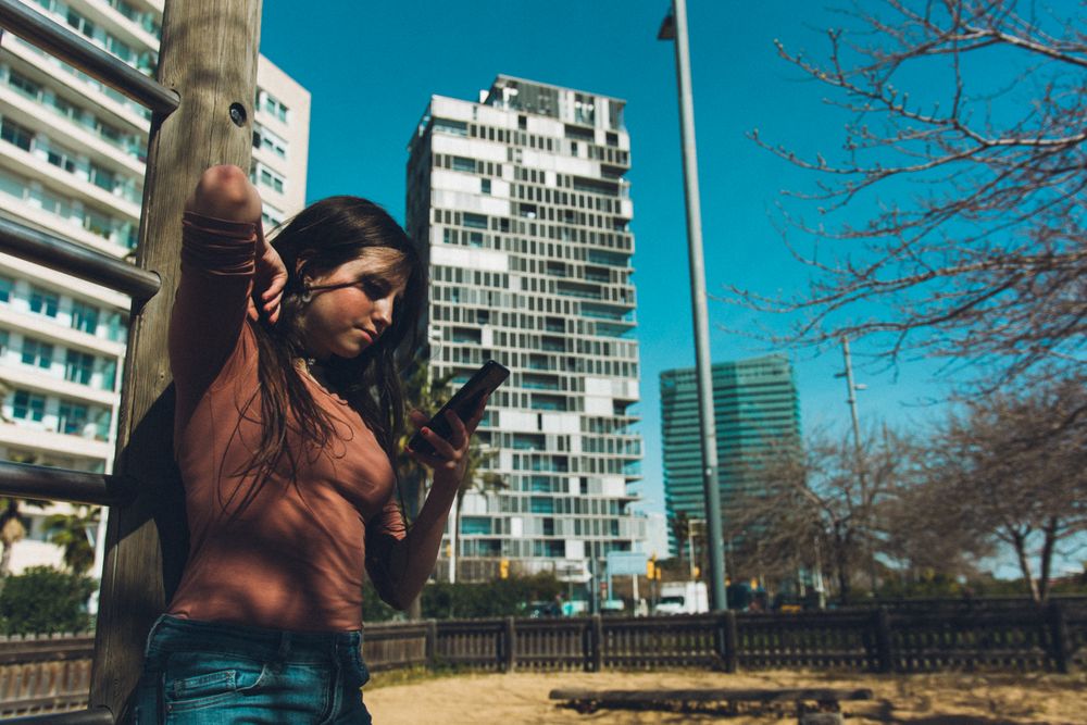 Teen girl looking at her smartphone.
