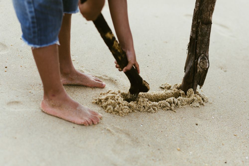 Crop Black boy playing on beach