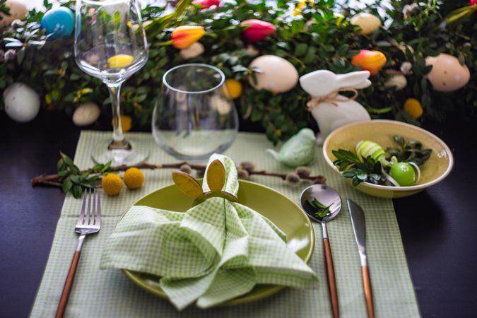 Easter table setting with rabbit napkin ring on pastel green napkin and plate