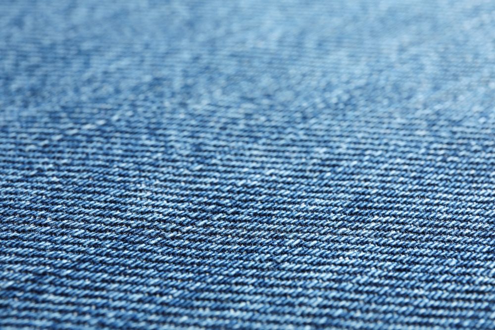 Texture of blue jeans as background, space for text