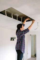Woman preparing extractor hood installation