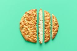 Focaccia on a green background, above view