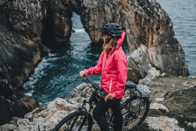 Anonymous female bicyclist on rocks