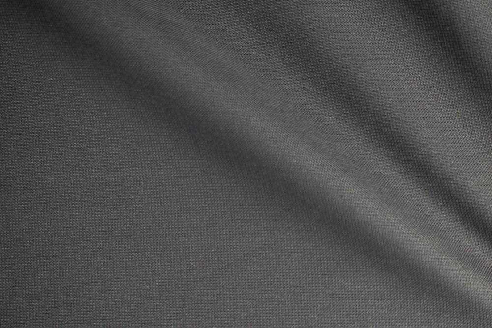 Wavy dark grey fabric background texture. shiny, glossy and elegant background.