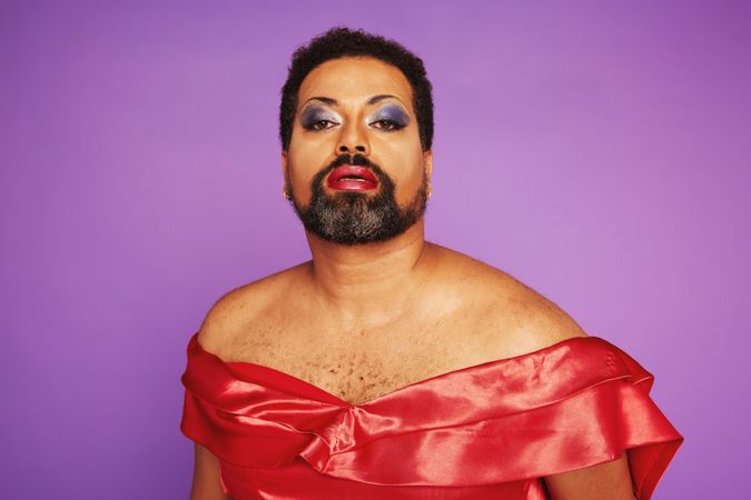 Elegant drag queen on purple background